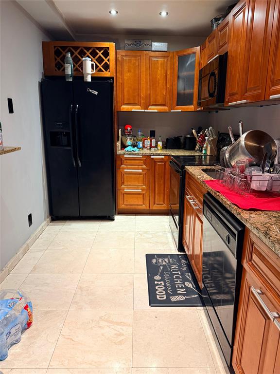 505 Spencer Drive, Unit 210 West Palm Beach, FL 33409 - Photo 9 of 12 a kitchen with granite countertop a stove and cabinets