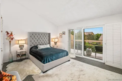 a bedroom with a large bed and a large window