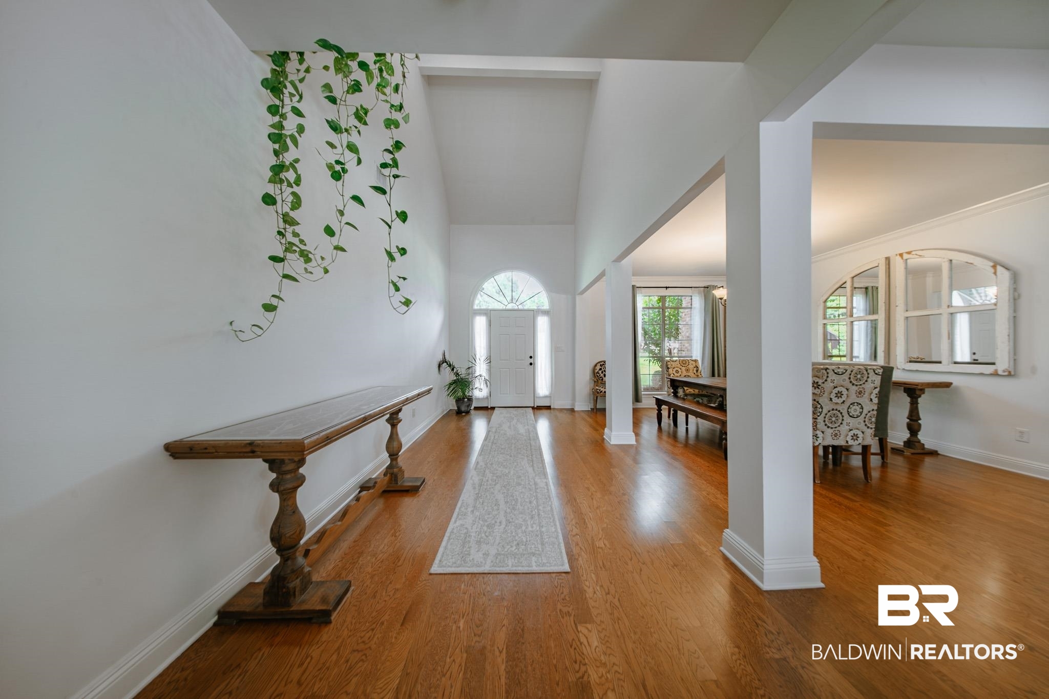 8421 Weatherford Court Daphne, AL 36527 - Photo 6 of 36 Entrance foyer featuring wood finished floors, high vaulted ceiling, and decorative columns