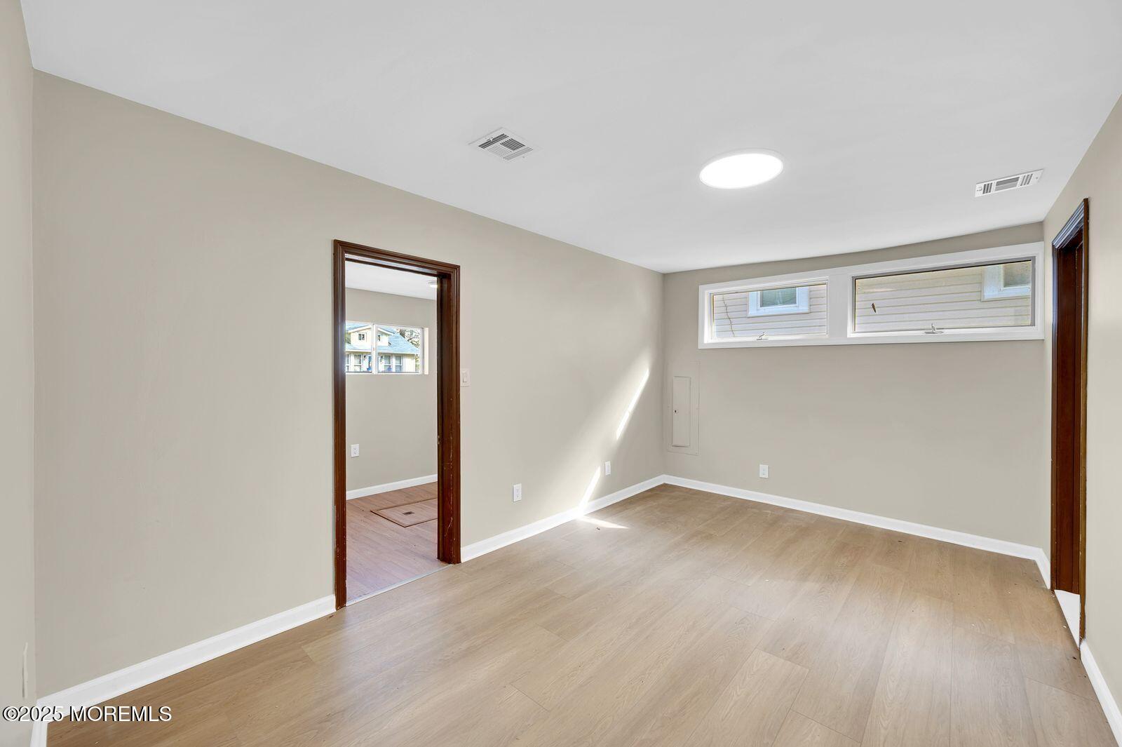 32 Lakewood Avenue Keansburg, NJ 07734 - Photo 17 of 30 an empty room with wooden floor and windows