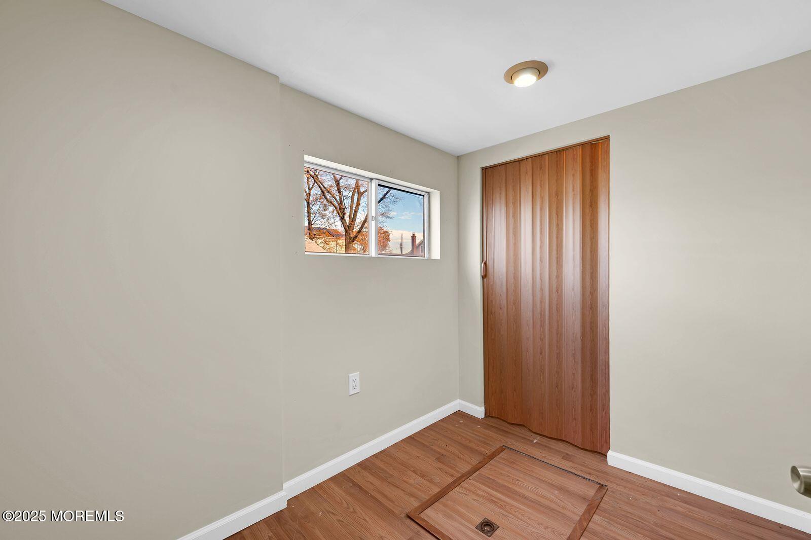 32 Lakewood Avenue Keansburg, NJ 07734 - Photo 18 of 30 a view of an empty room with wooden floor and a window
