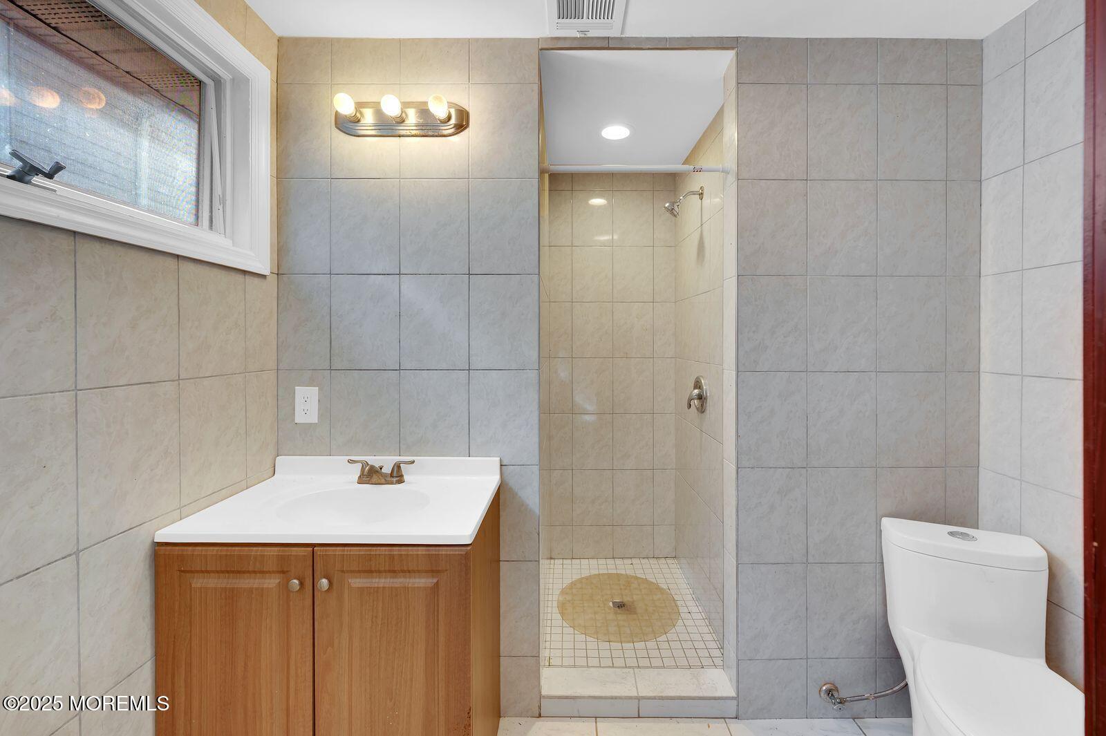 32 Lakewood Avenue Keansburg, NJ 07734 - Photo 20 of 30 a bathroom with a sink a toilet and shower