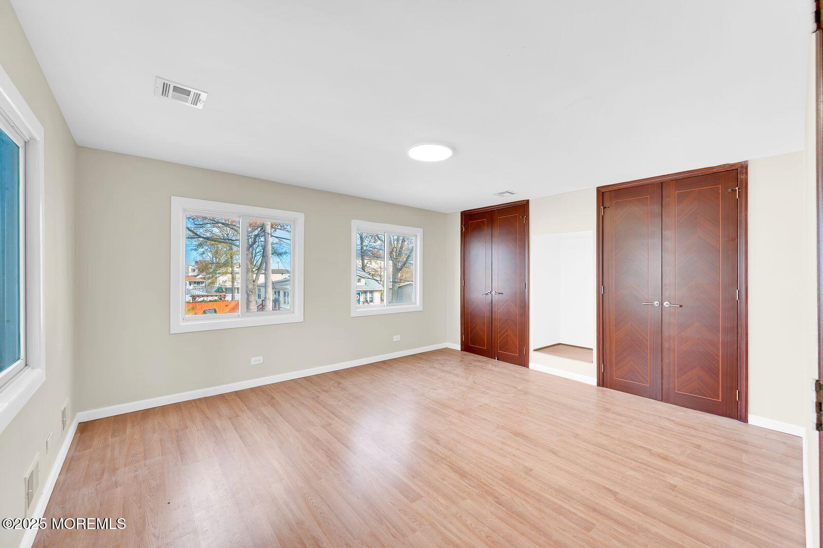 32 Lakewood Avenue Keansburg, NJ 07734 - Photo 23 of 30 a view of an empty room with wooden floor and a window