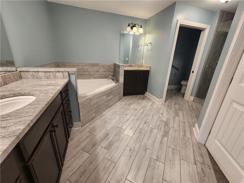 7441 Dodson Road Brookville, OH 45309 - Photo 23 of 50 This spacious bathroom offers a large soaking tub and dual vanities for ultimate comfort.