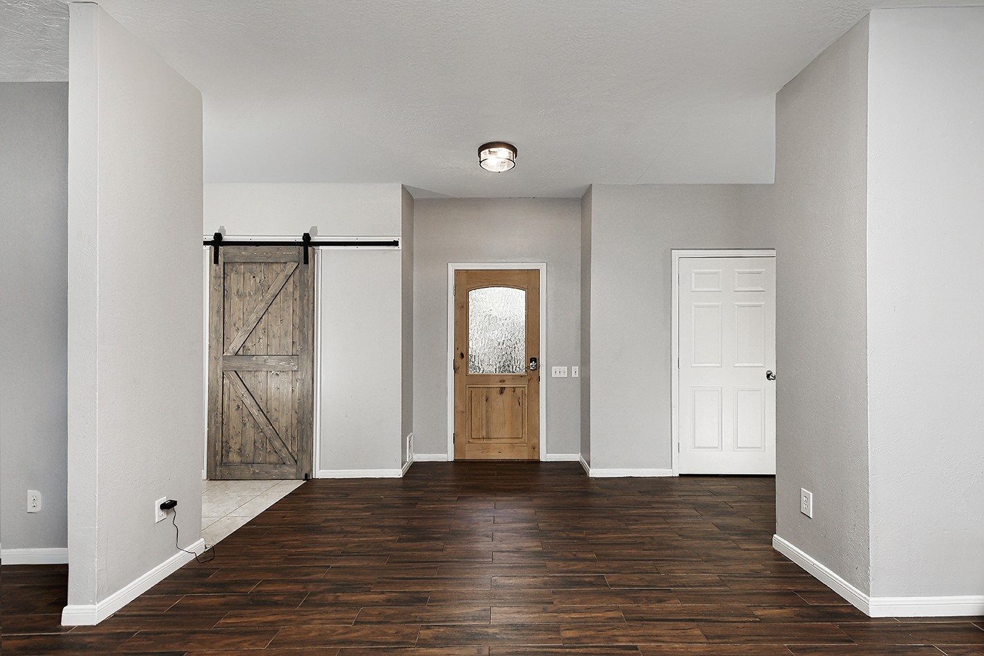 44 Lake Forest Circle Conroe, TX 77384 - Photo 2 of 49 a view of an empty room with wooden floor and a window
