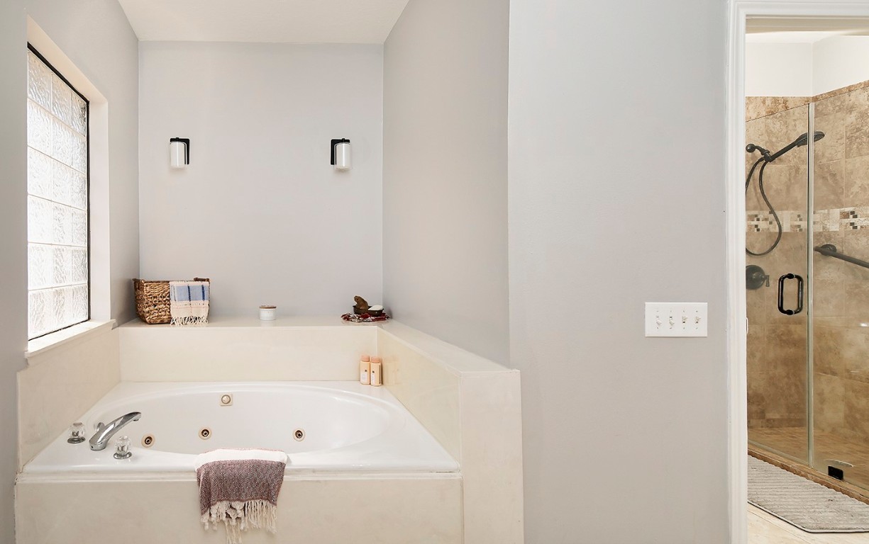 44 Lake Forest Circle Conroe, TX 77384 - Photo 26 of 49 a bathroom with a bathtub and a shower