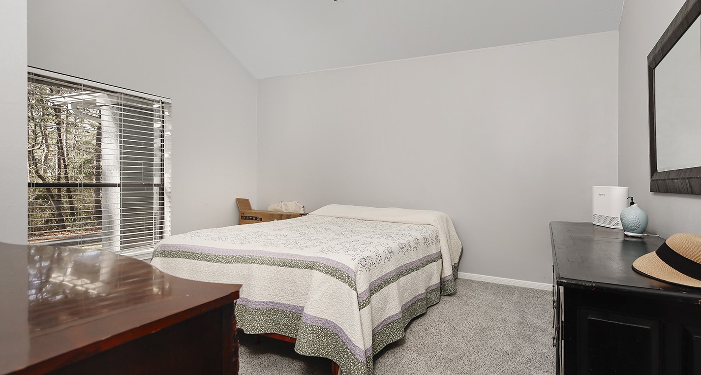 44 Lake Forest Circle Conroe, TX 77384 - Photo 27 of 49 a bedroom with a bed and a window