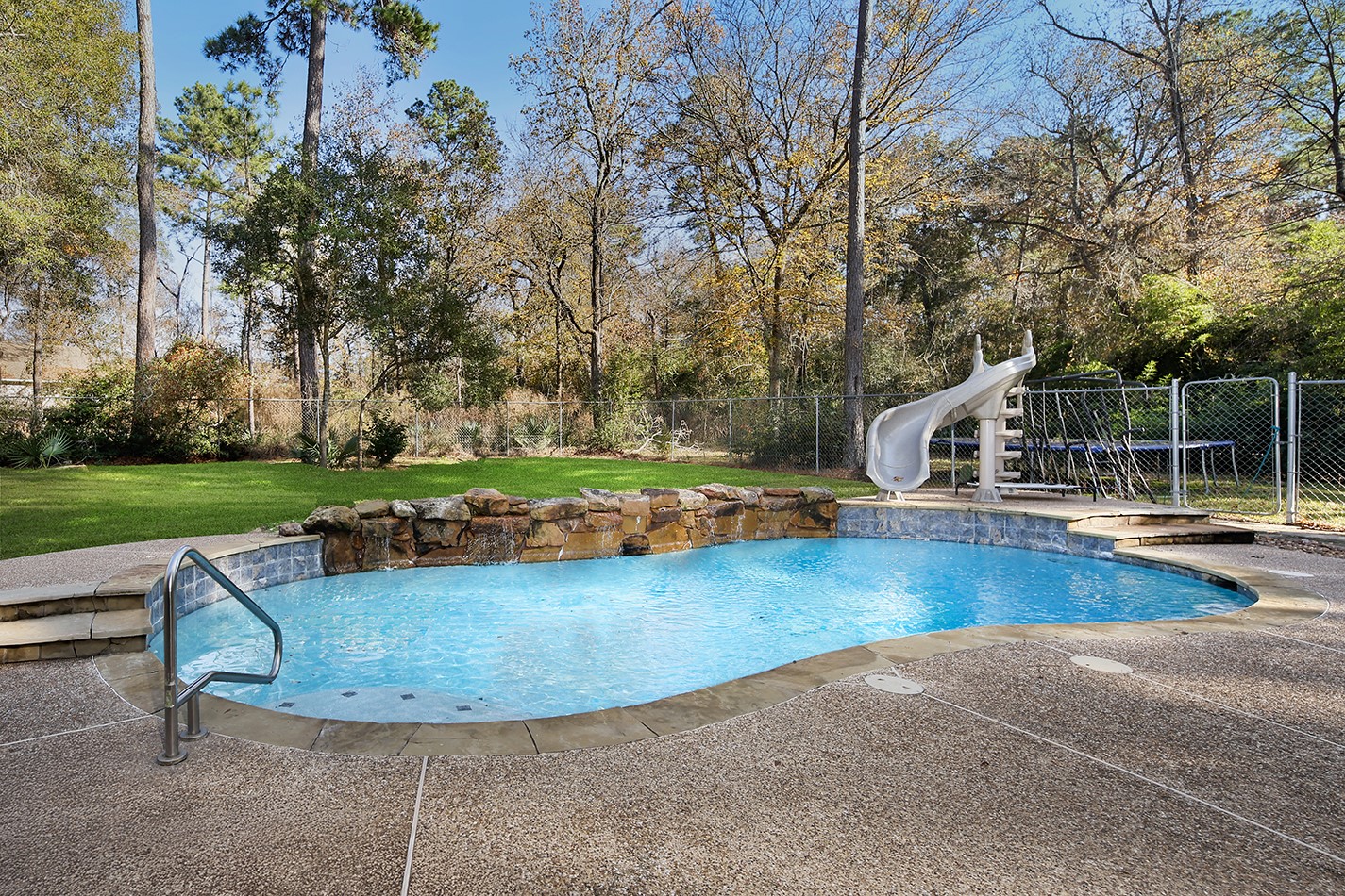 44 Lake Forest Circle Conroe, TX 77384 - Photo 33 of 49 a view of a swimming pool and deck in the backyard