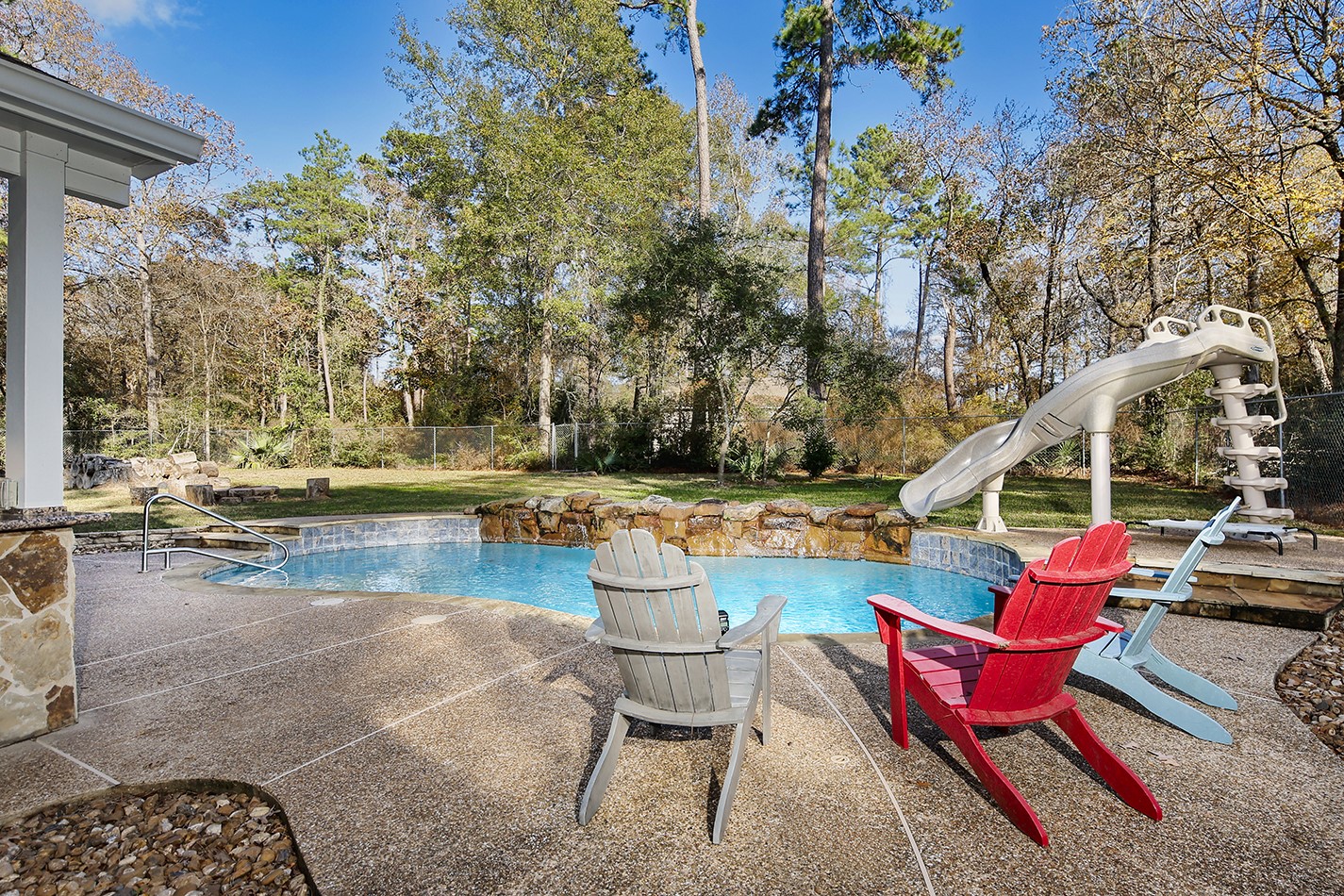 44 Lake Forest Circle Conroe, TX 77384 - Photo 34 of 49 a view of swimming pool with outdoor seating