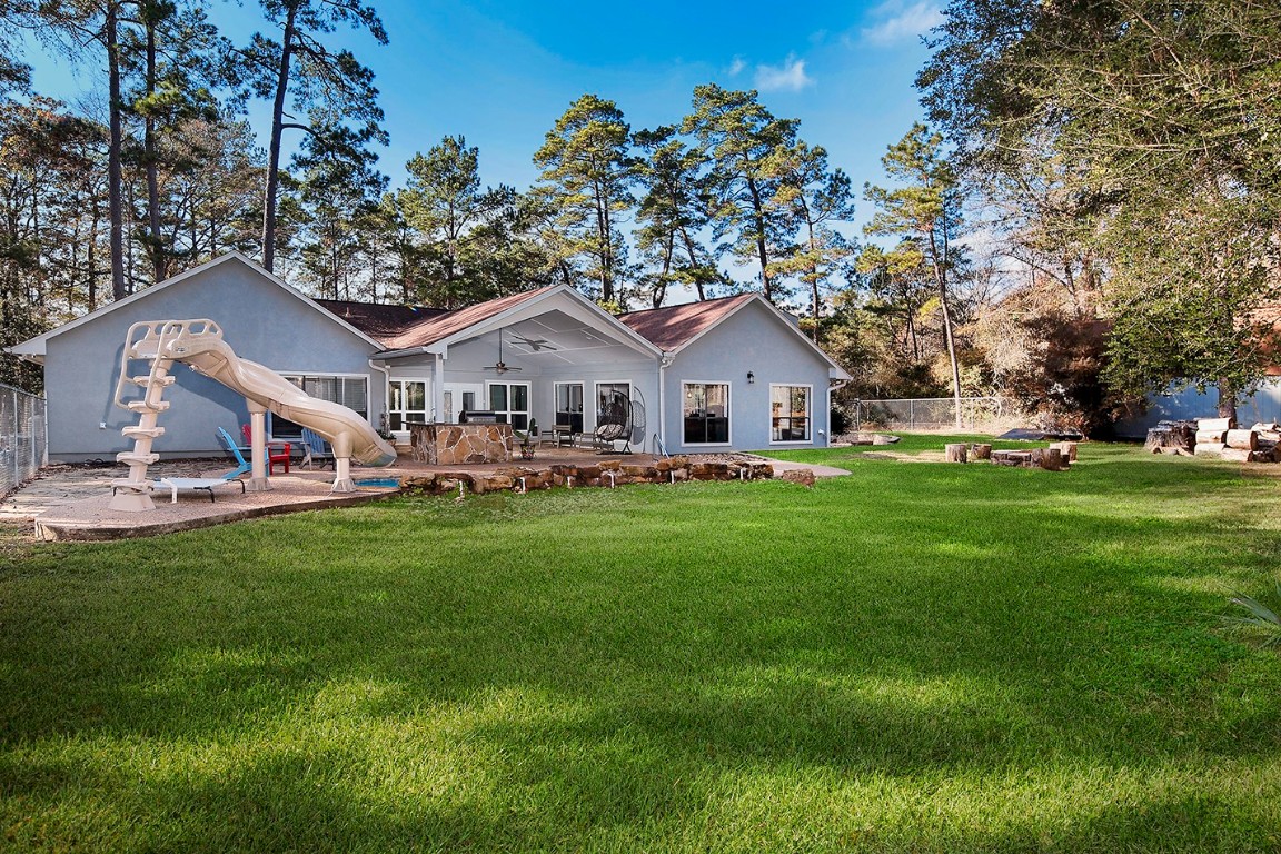 44 Lake Forest Circle Conroe, TX 77384 - Photo 37 of 49 a front view of a house with a garden