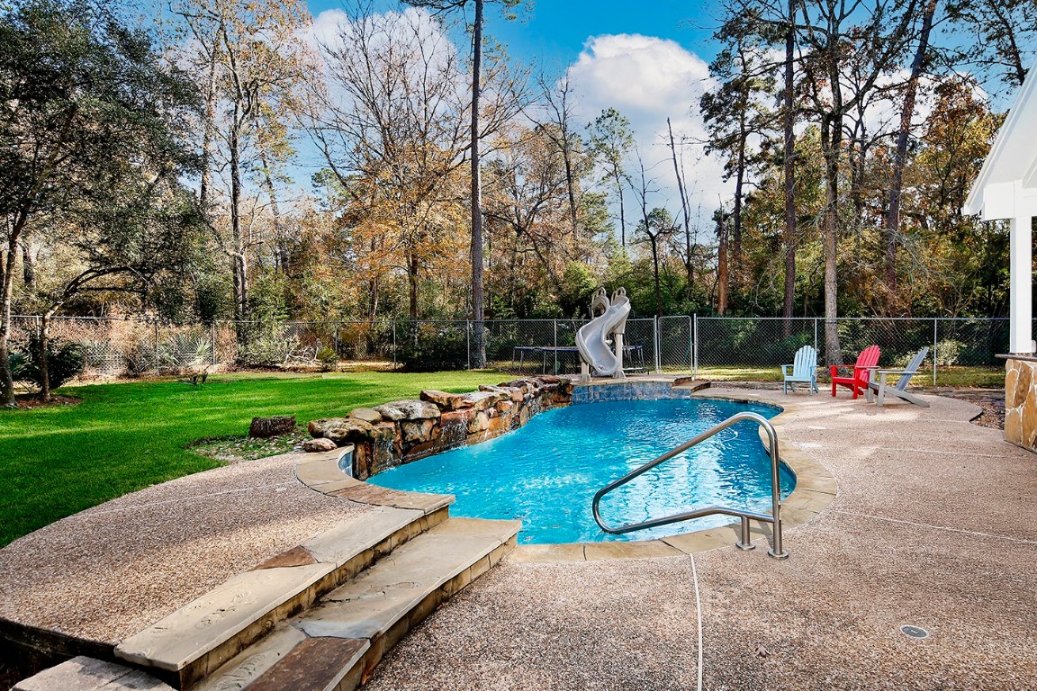 44 Lake Forest Circle Conroe, TX 77384 - Photo 39 of 49 a view of a backyard with swimming pool