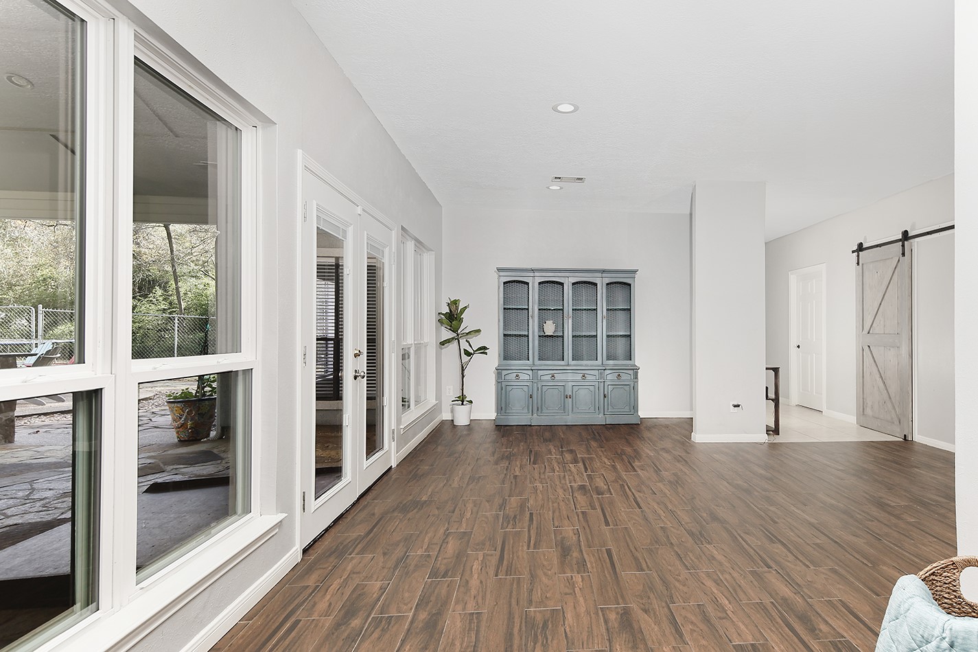 44 Lake Forest Circle Conroe, TX 77384 - Photo 7 of 49 a view of a big room with wooden floor and windows