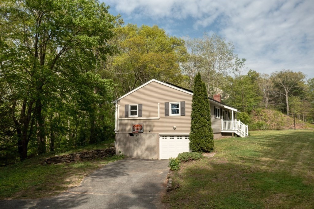 516 Old Wales Road Monson, MA 01057 - Photo 11 of 36 a view of a house with a yard and large trees