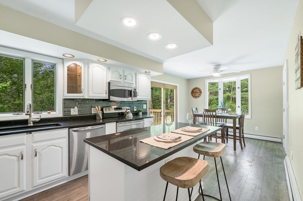 516 Old Wales Road Monson, MA 01057 - Photo 20 of 36 a kitchen with sink stove dining table and chairs