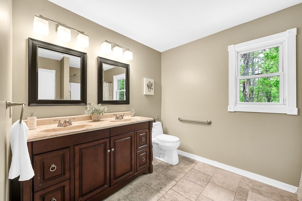 516 Old Wales Road Monson, MA 01057 - Photo 25 of 36 a bathroom with a double vanity sink a toilet and a mirror