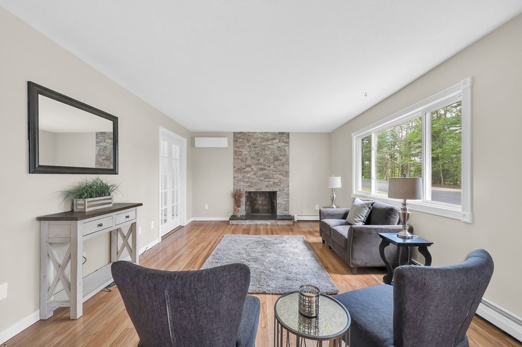 516 Old Wales Road Monson, MA 01057 - Photo 4 of 36 a living room with furniture two window and a fireplace