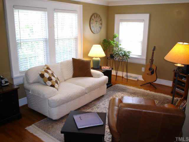 300 West Whitaker Mill Road Raleigh, NC 27608 - Photo 2 of 10 a living room with furniture a window and a lamp