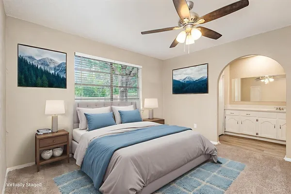 a bedroom with a large bed and a window