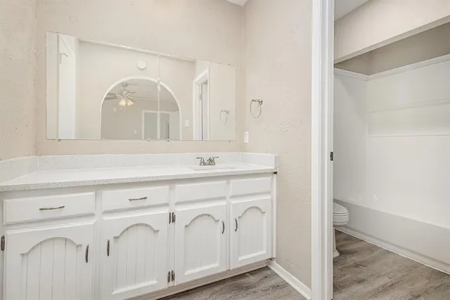 a bathroom with a sink a vanity and a mirror