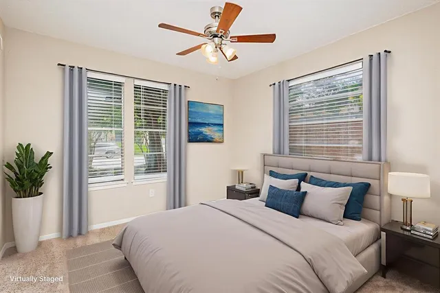 a bedroom with a large bed and a chandelier