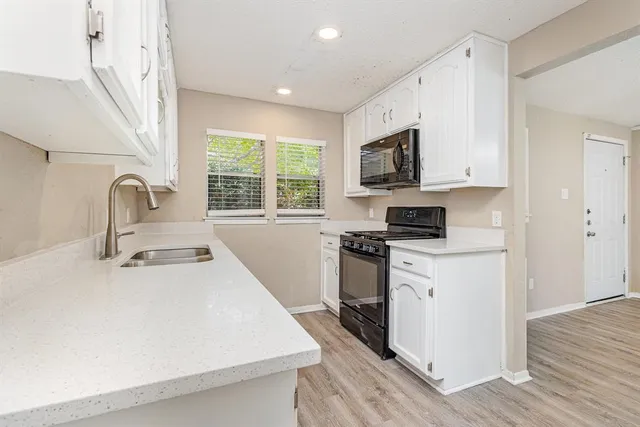 a kitchen with stainless steel appliances a sink stove and a refrigerator