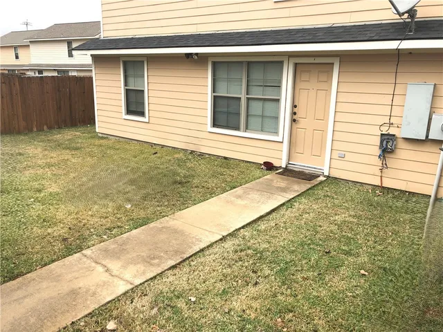 a view of house with backyard
