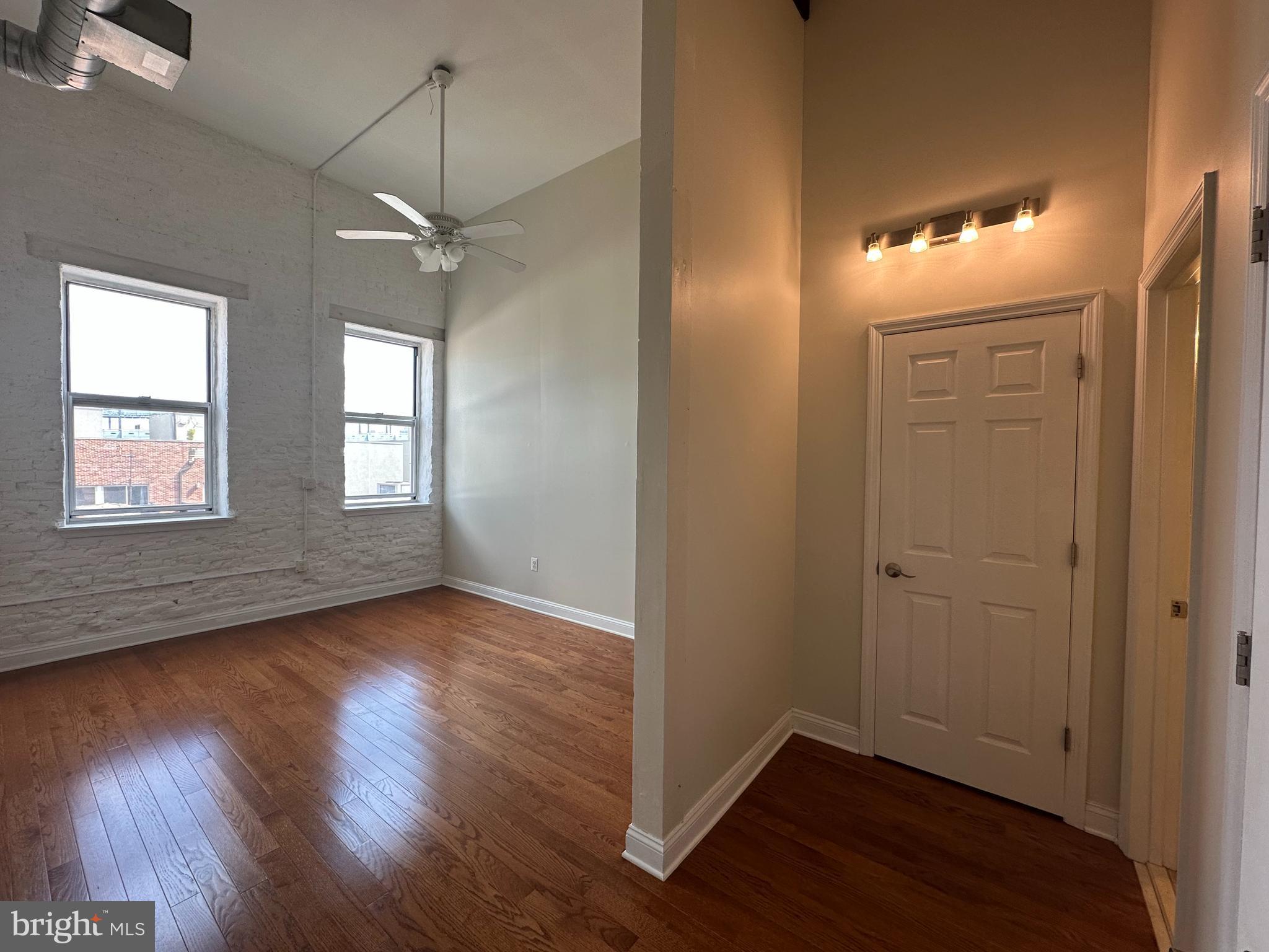 141 North 2nd Street, Unit 3C Philadelphia, PA 19106 - Photo 14 of 28 a view of an empty room with wooden floor and a window