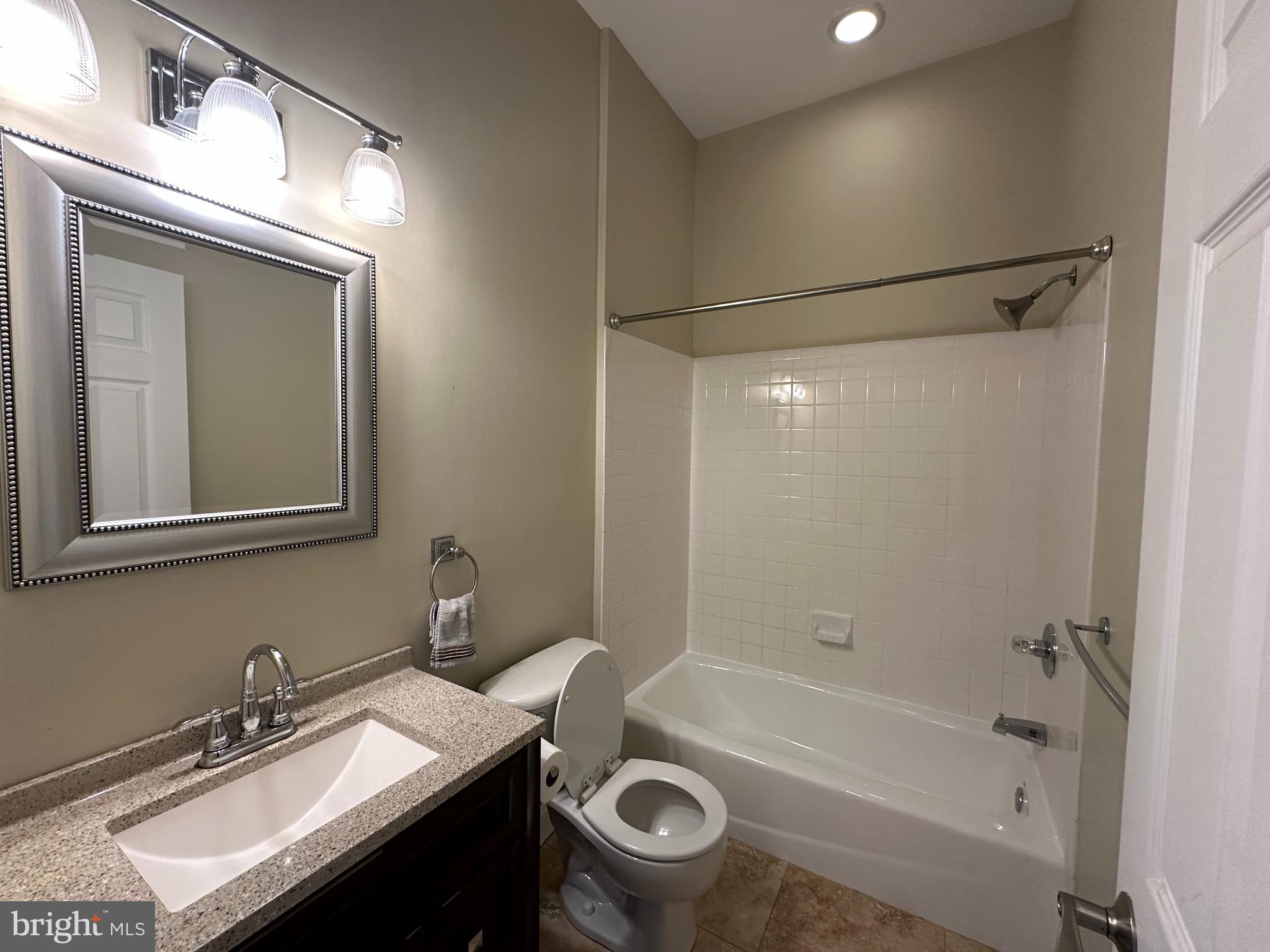 141 North 2nd Street, Unit 3C Philadelphia, PA 19106 - Photo 15 of 28 a bathroom with a granite countertop sink mirror toilet and bathtub