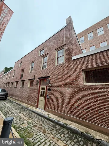a view of a brick house with many windows