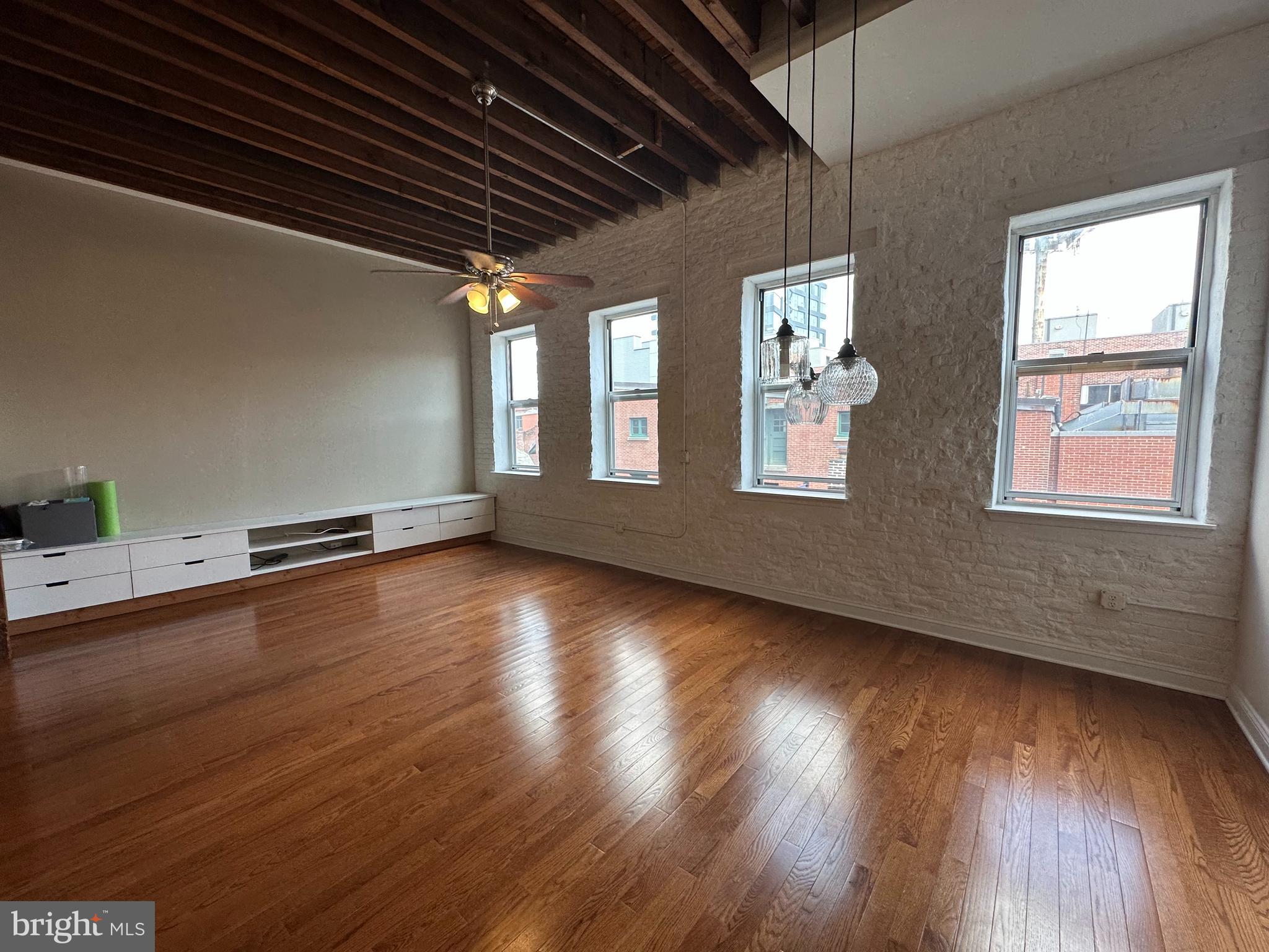 141 North 2nd Street, Unit 3C Philadelphia, PA 19106 - Photo 4 of 28 an empty room with wooden floor and windows