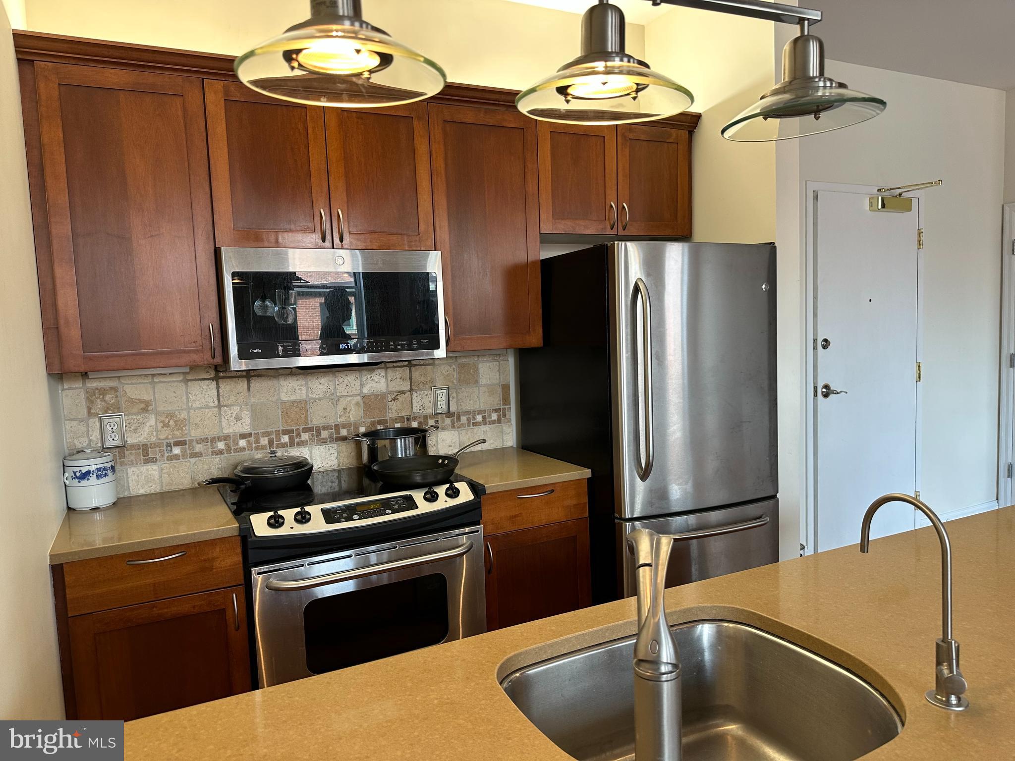 141 North 2nd Street, Unit 3C Philadelphia, PA 19106 - Photo 8 of 28 a kitchen with stainless steel appliances granite countertop a refrigerator a stove and a sink