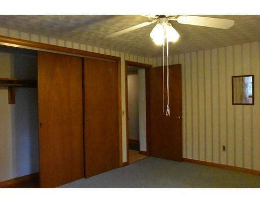 50 Mason Road Dudley, MA 01571 - Photo 19 of 26 a bedroom with a bed and a chandelier
