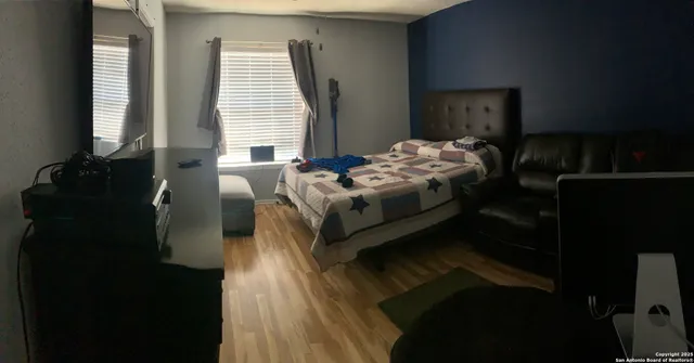 a bedroom with bed and window