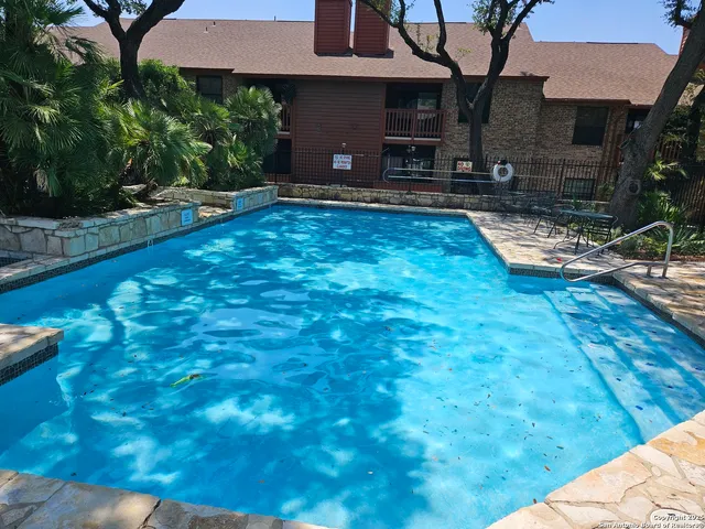 a view of a swimming pool with a patio