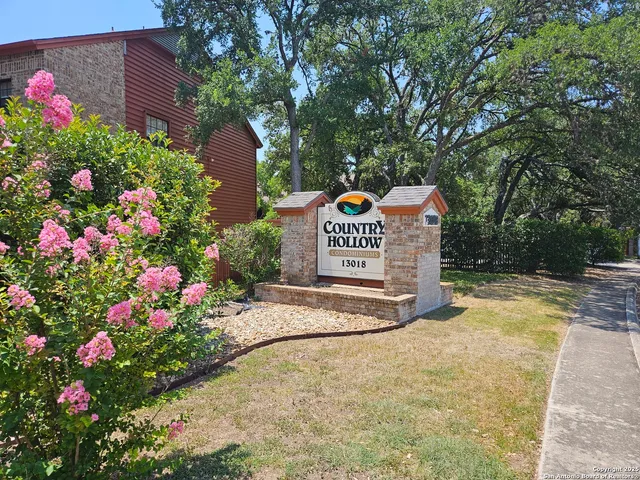 a sign that is in front of flowers