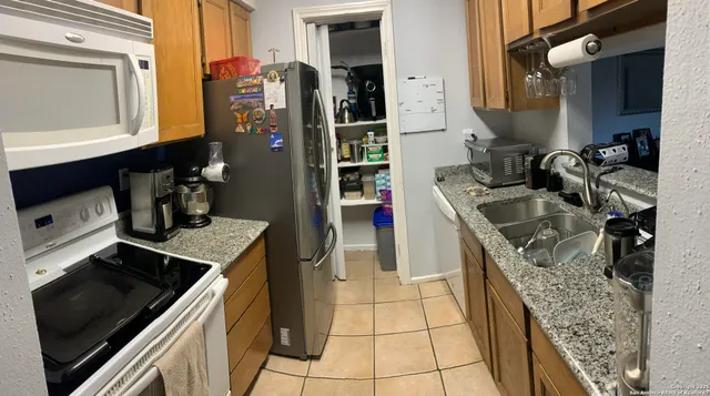 a kitchen that has a sink and a stove