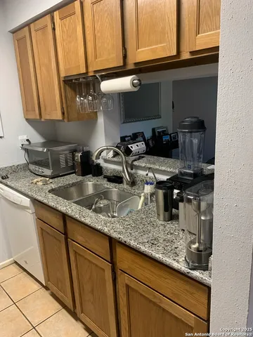 a kitchen with sink a microwave and cabinets