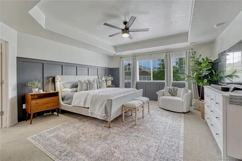 a spacious bedroom with a bed and a couch