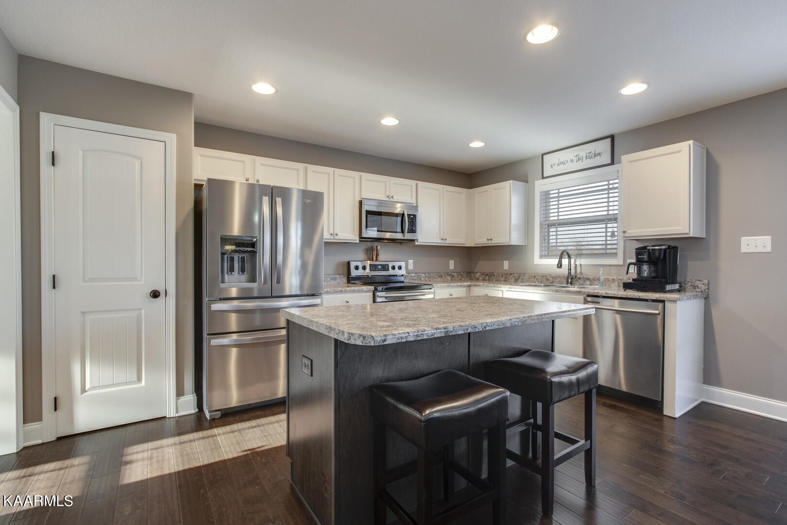3417 Boulder Point Lane Powell, TN 37849 - Photo 11 of 31 a kitchen with stainless steel appliances granite countertop a refrigerator a sink dishwasher a stove and white cabinets with wooden floor