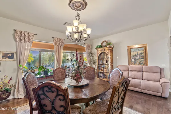 a living room with furniture a wooden floor and chandelier
