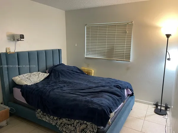 a bedroom with a bed and dresser