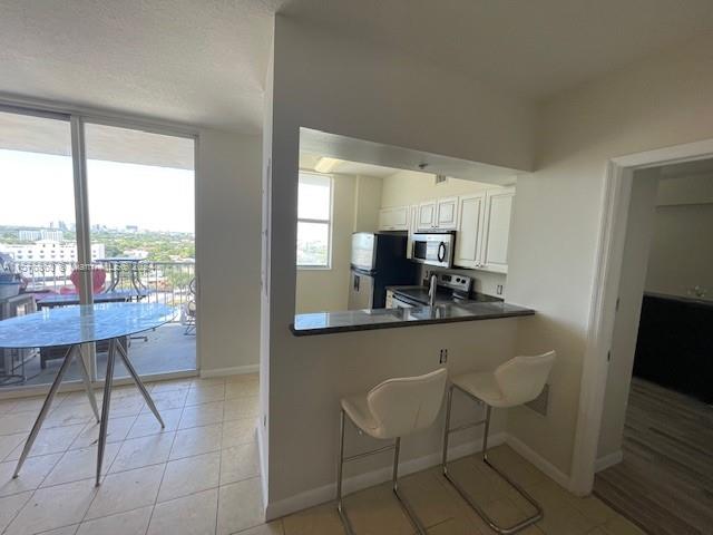 West Flagler Miami, FL 33125 - Photo 3 of 22 a kitchen with a sink and a refrigerator