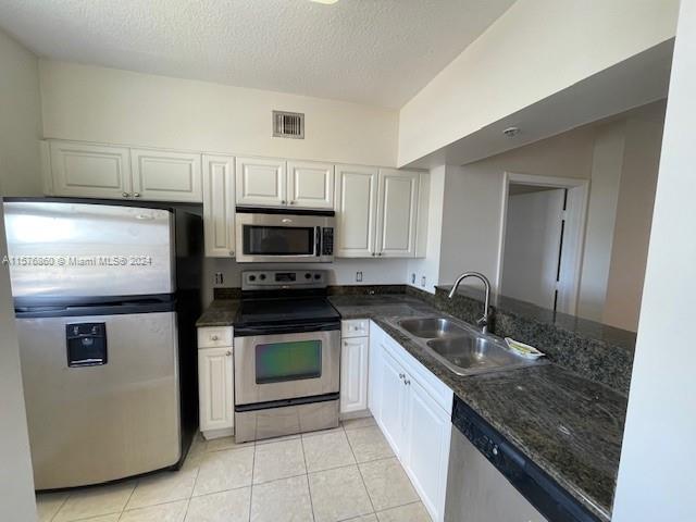 West Flagler Miami, FL 33125 - Photo 6 of 22 a kitchen with stainless steel appliances granite countertop a sink stove and microwave