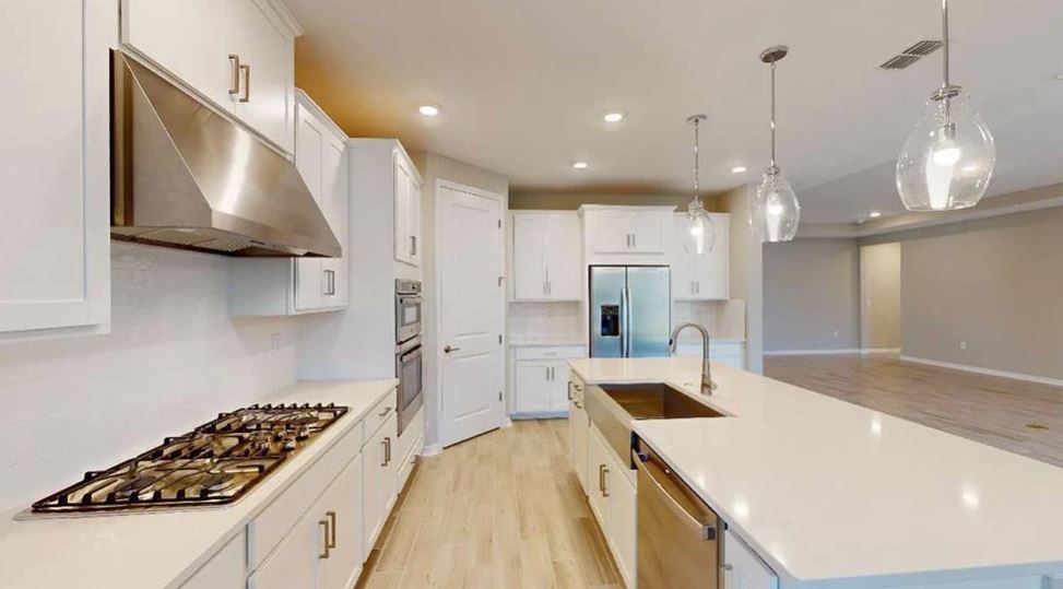 86571 Oar Row Yulee, FL 32097 - Photo 4 of 20 a kitchen with stainless steel appliances granite countertop a sink a stove and a refrigerator