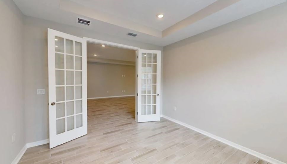 86571 Oar Row Yulee, FL 32097 - Photo 10 of 20 an empty room with wooden floor and cabinet