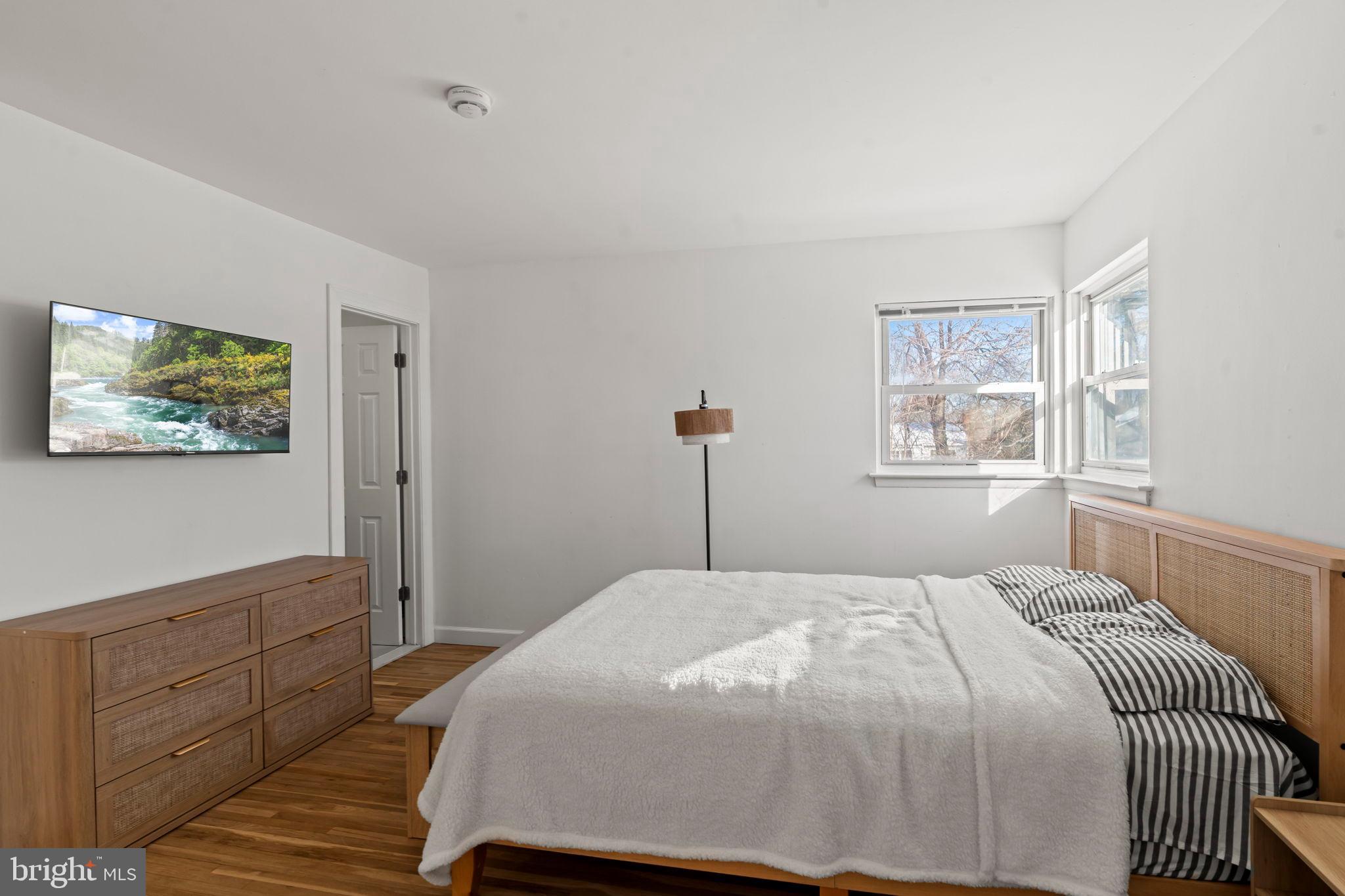 209 Front Street Mount Holly, NJ 08060 - Photo 14 of 35 a bedroom with a large bed and a window