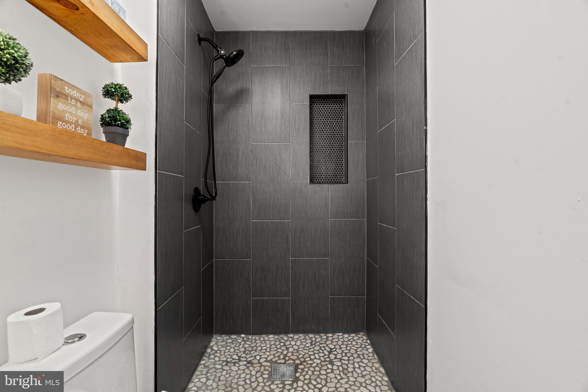 209 Front Street Mount Holly, NJ 08060 - Photo 15 of 35 Sleek modern shower with natural stone floor.