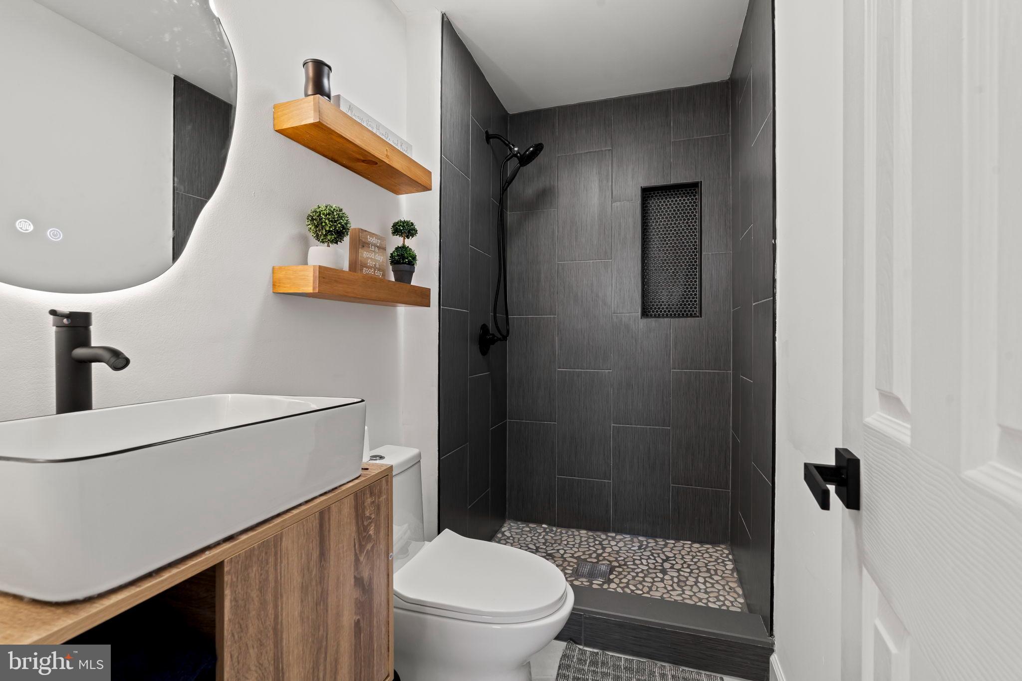 209 Front Street Mount Holly, NJ 08060 - Photo 15 of 35 a bathroom with a sink a toilet and shower