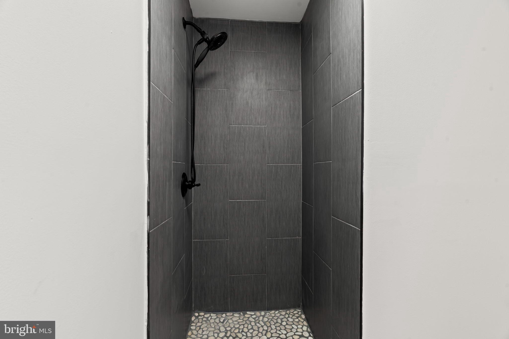 209 Front Street Mount Holly, NJ 08060 - Photo 17 of 35 Sleek modern shower with elegant tiles.