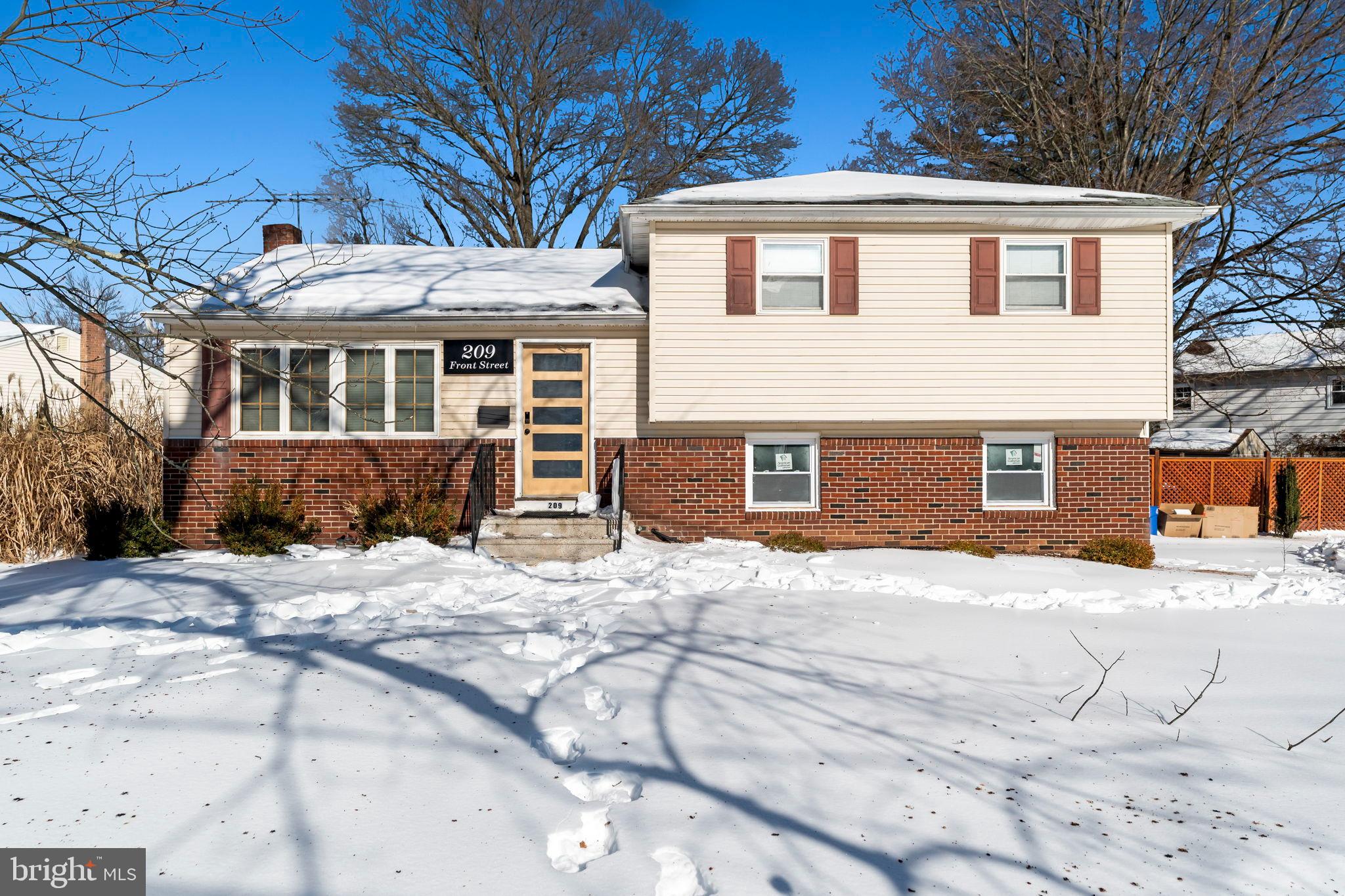 209 Front Street Mount Holly, NJ 08060 - Photo 2 of 35 a front view of a house with a yard covered in snow